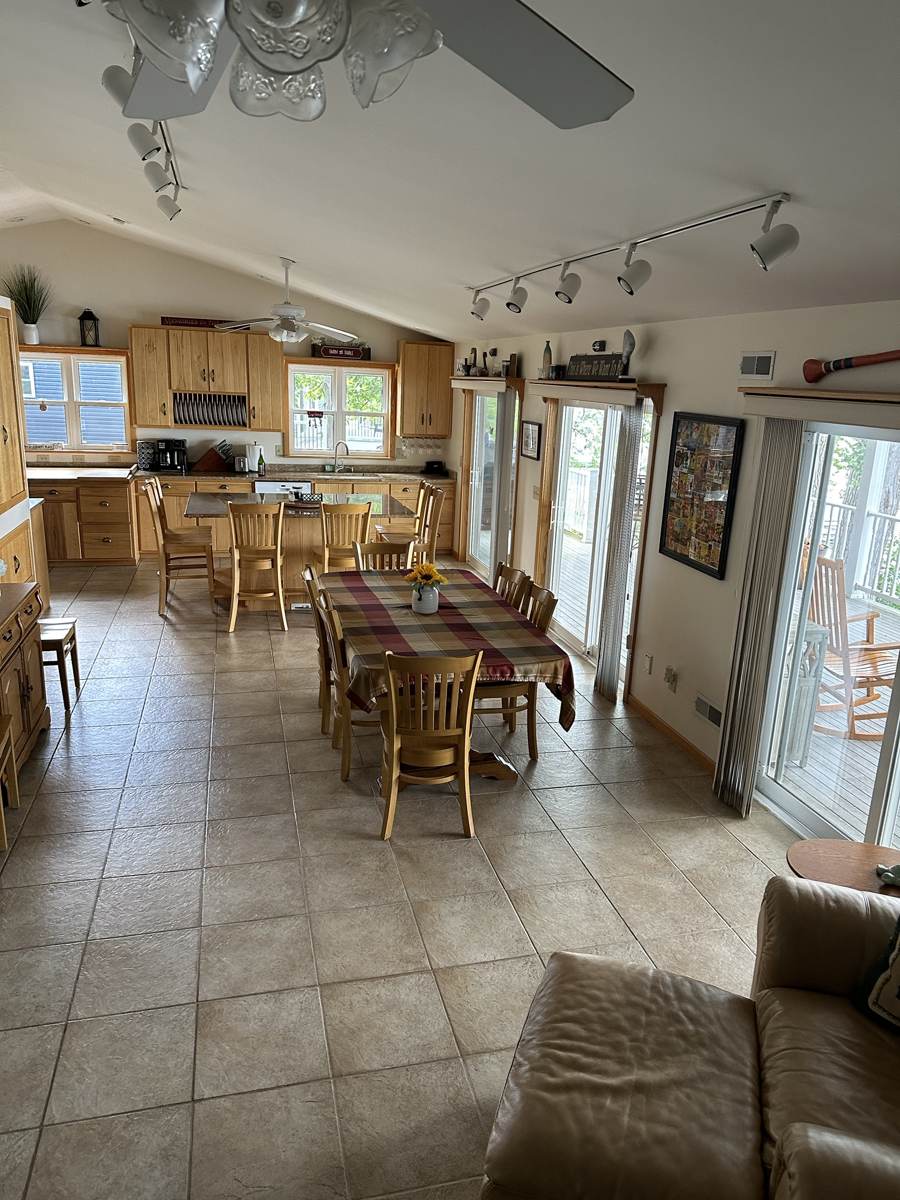 Open kitchen, dining and living space with doors to the porch