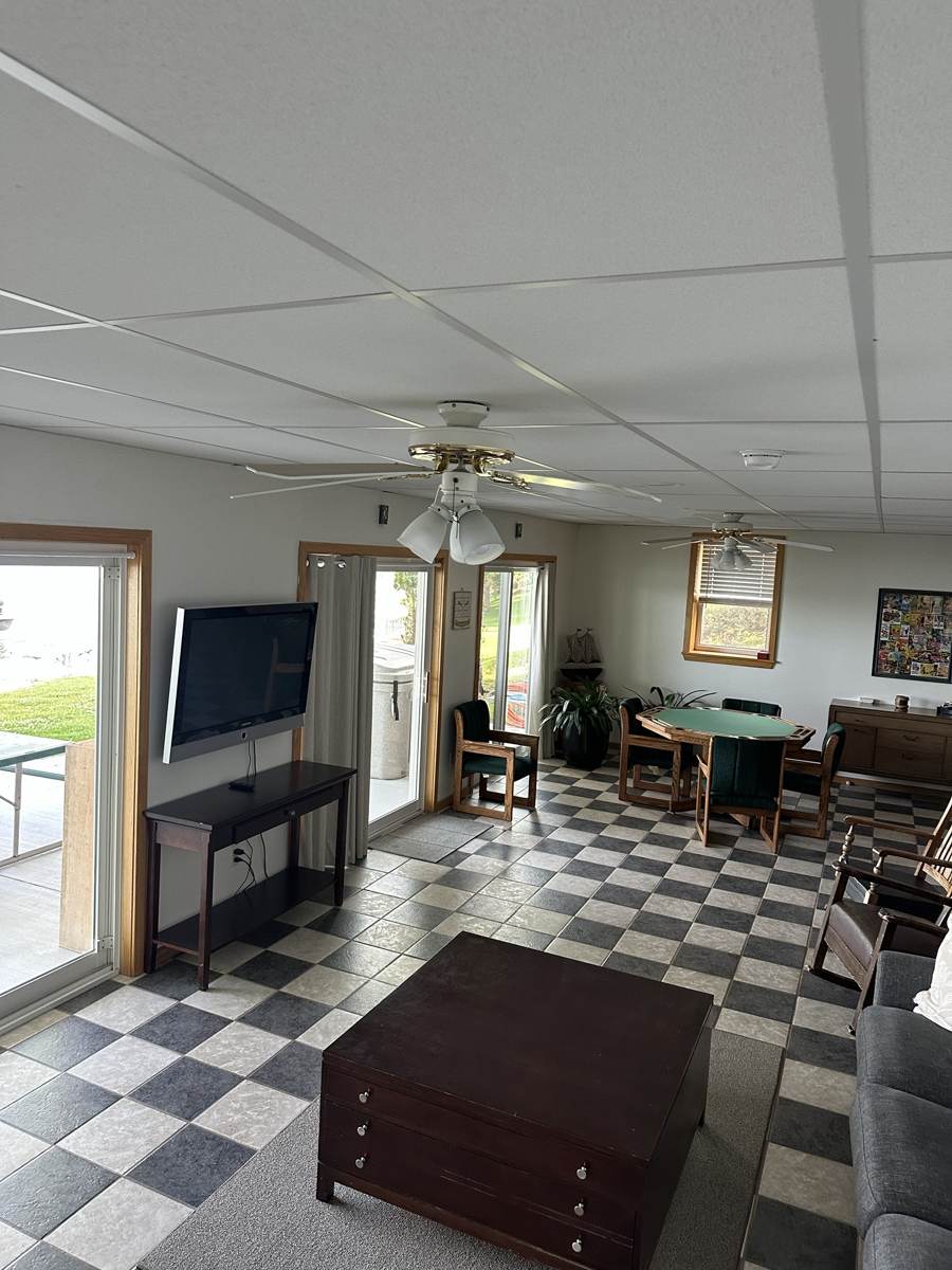 Family room with TV, card table and doors to the patio