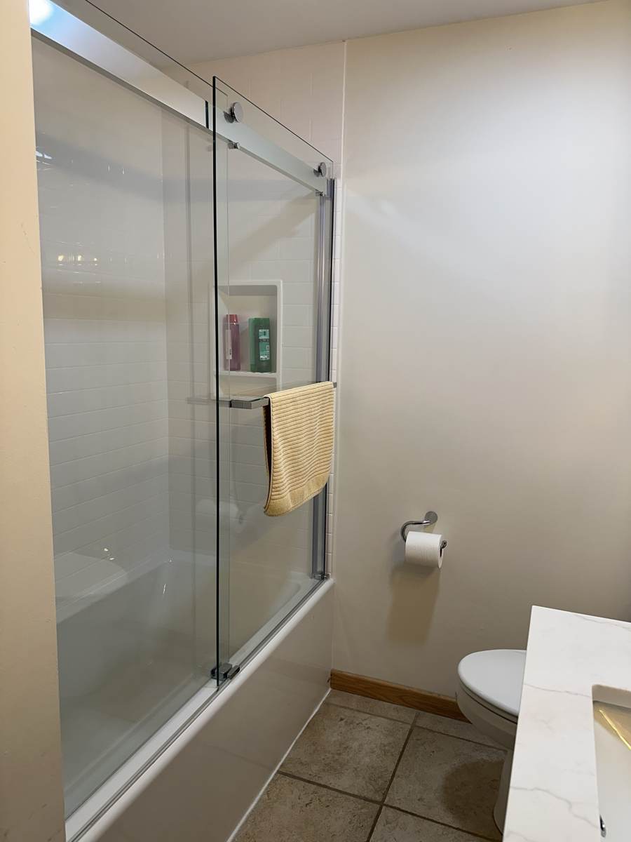 Tub and shower with a glass slider